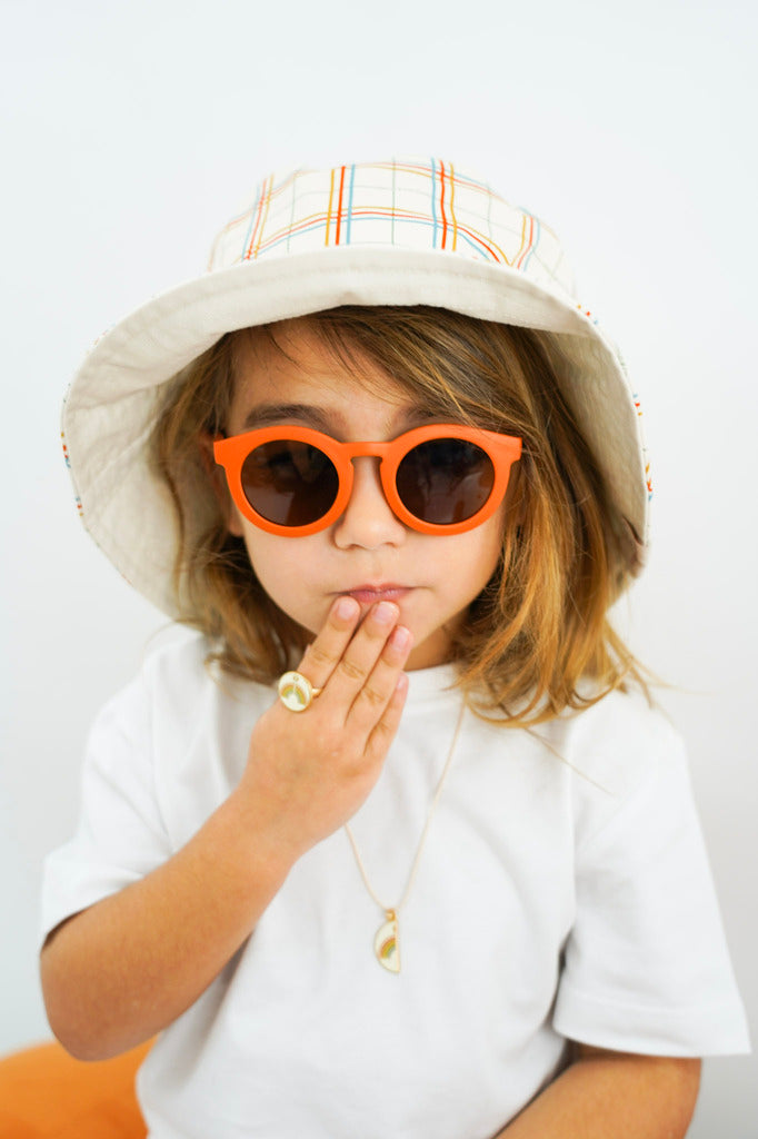 Sustainable sunglasses in orange by Grech & Co are eco-friendly/non-toxic break-resistant material with polarised lenses and UV400 protection. Best kids gift.