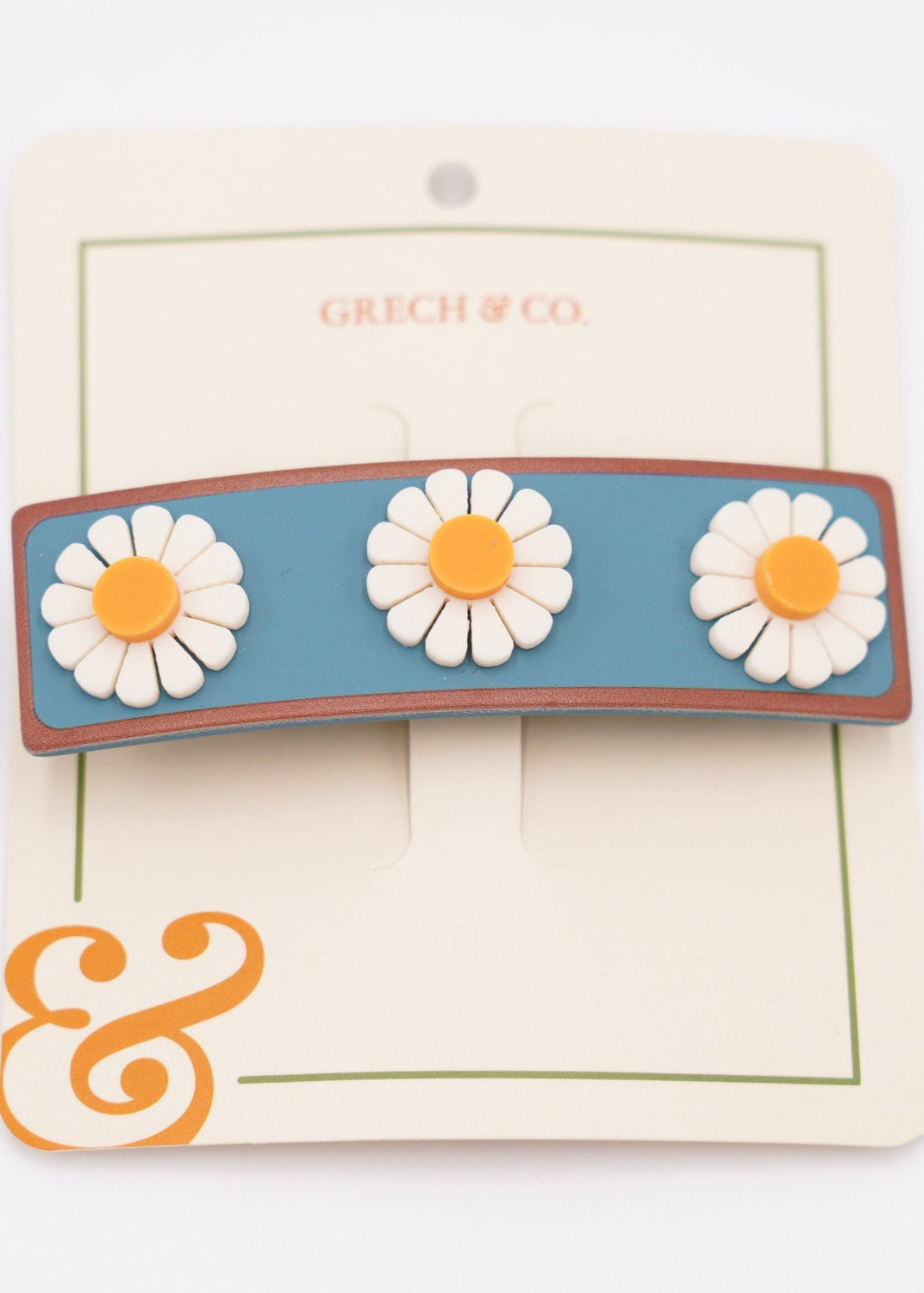 Flat lay of Grech & Co blue flower wide bar hair clip 6cm sustainable acetate