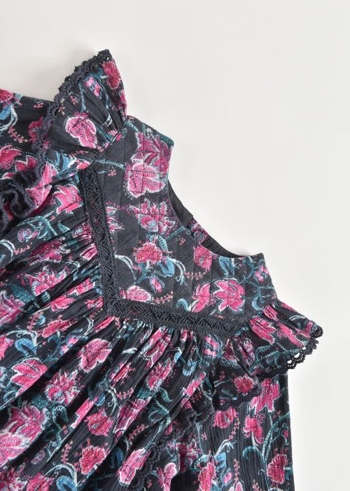 "Girl wearing Dress Lara in charcoal wildflowers - lifestyle shot showing knee-length fi