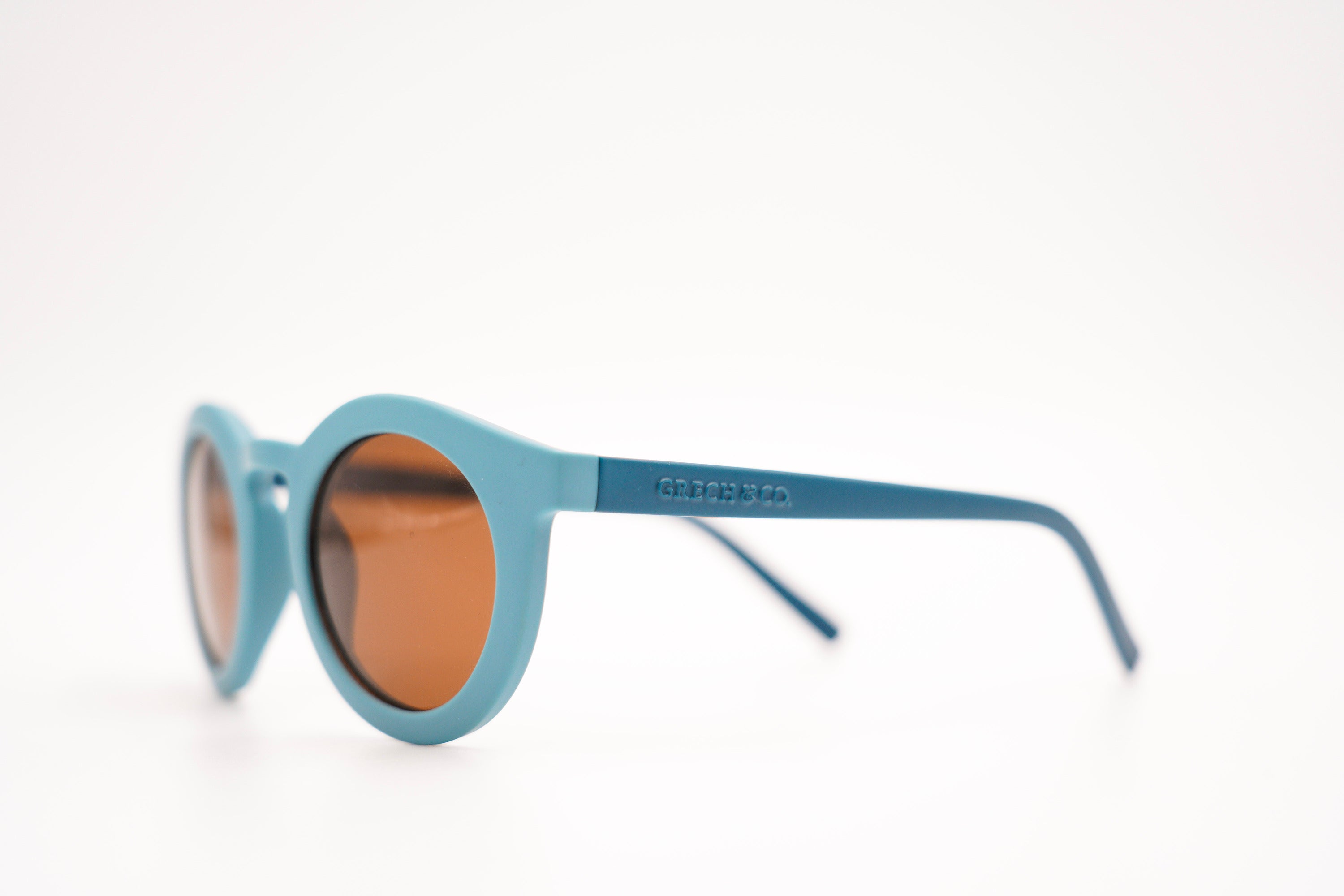 Sustainable sunglasses fir adults in blue are made with eco-friendly/non-toxic break-resistant material with UV400 protection. Mini-Me styles are available.