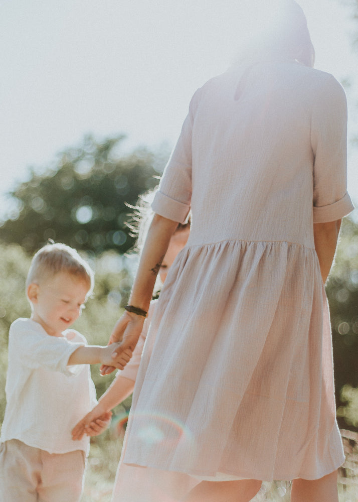 Women wearing soft pink organic muslin dress, Back to Nature collection lifestyle shot by Tiny Bunny | MiliMilu sustainable fashion