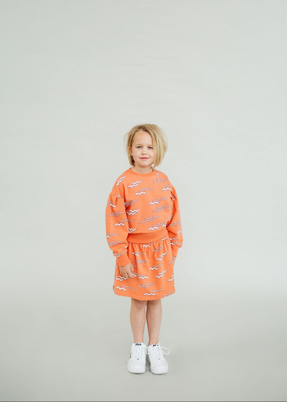 Wave print organic cotton jumper detail, showing puff sleeve design and slightly cropped fit.