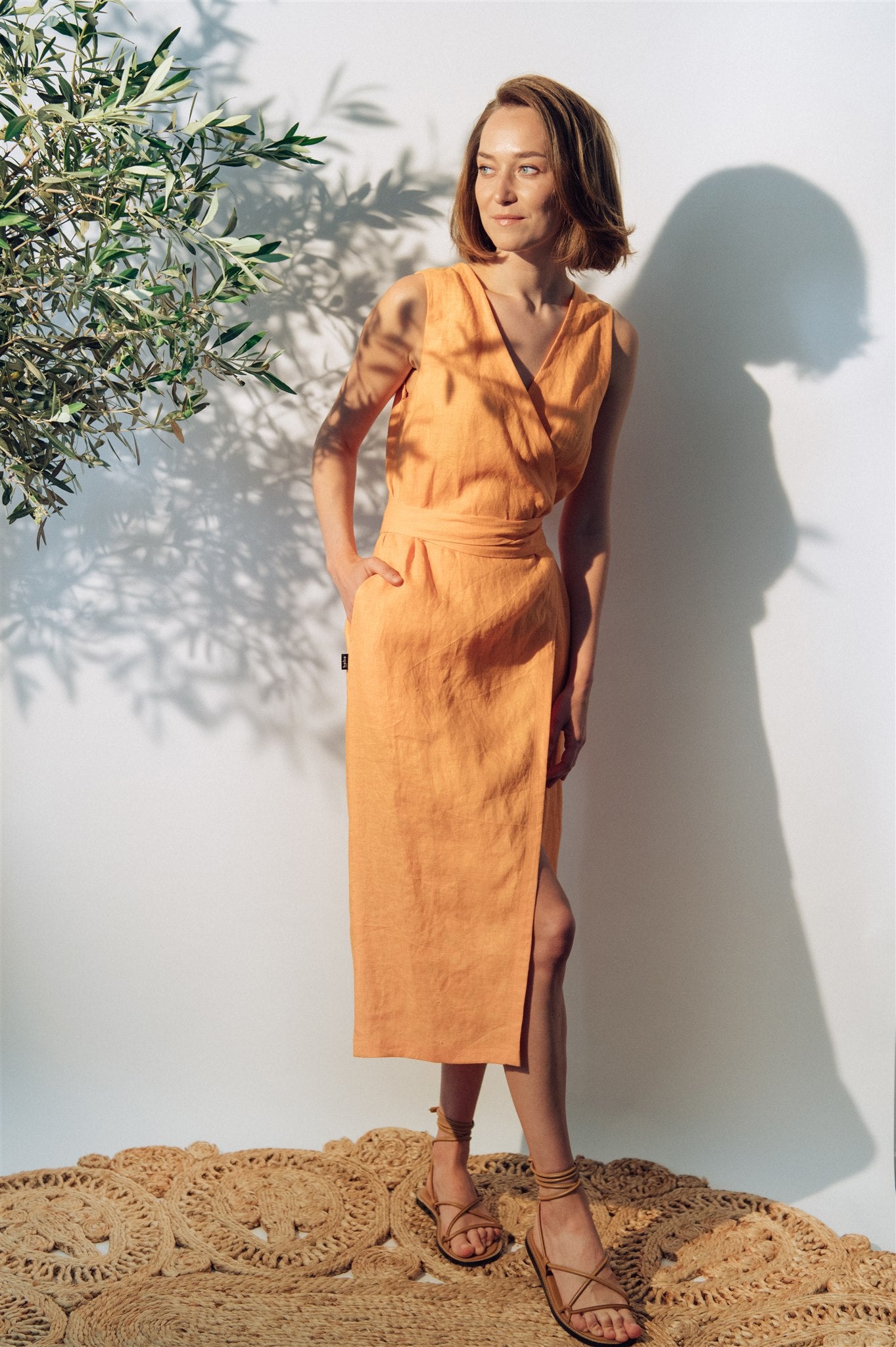 The sustainable and breathable women's linen midi wrap dress in apricot colour will become your wardrobe staple. Linen is perfect for hot and humid weather.