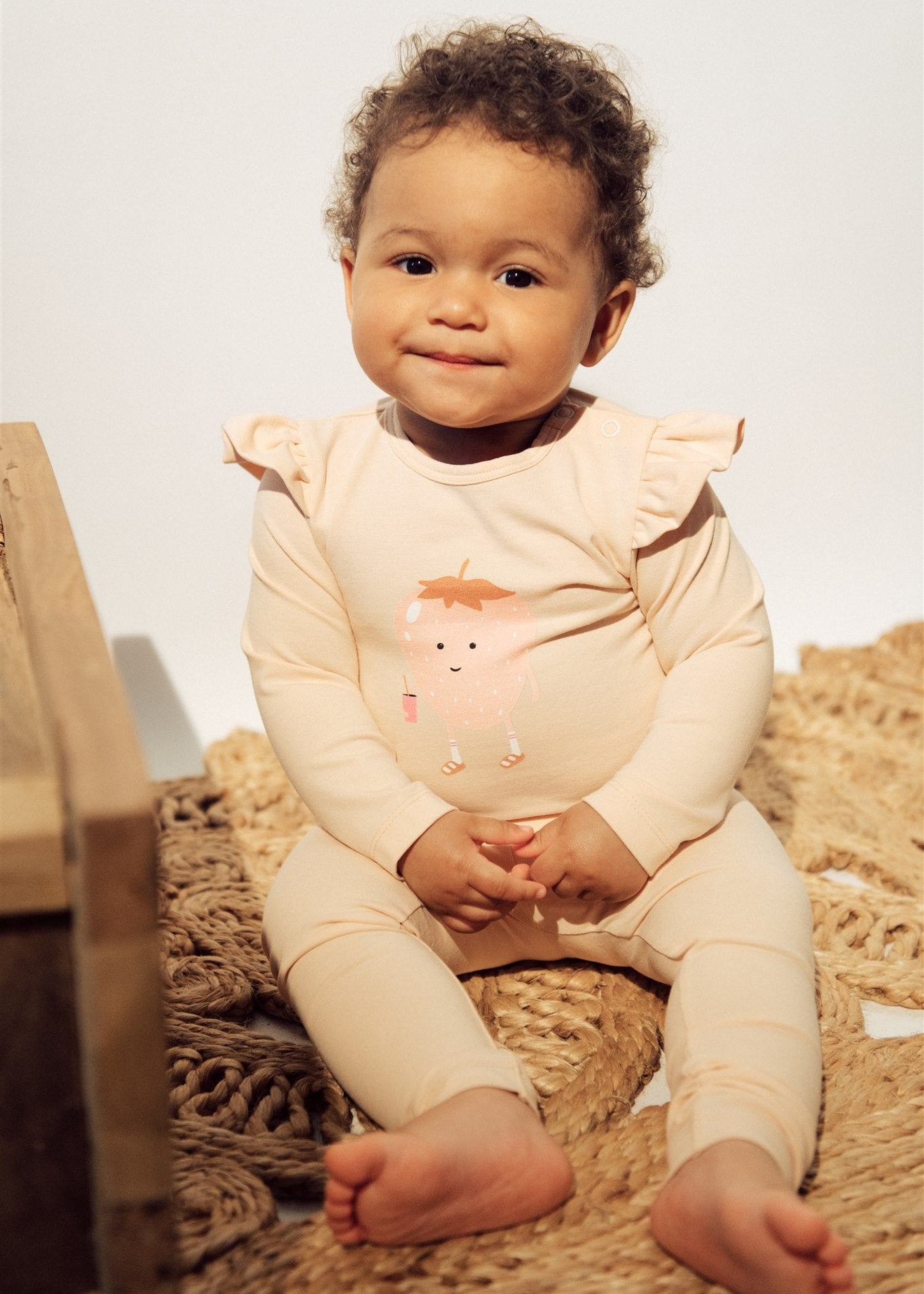 Breathable organic cotton baby girl bodysuit in light pink — snap buttons, gentle on sensitive skin