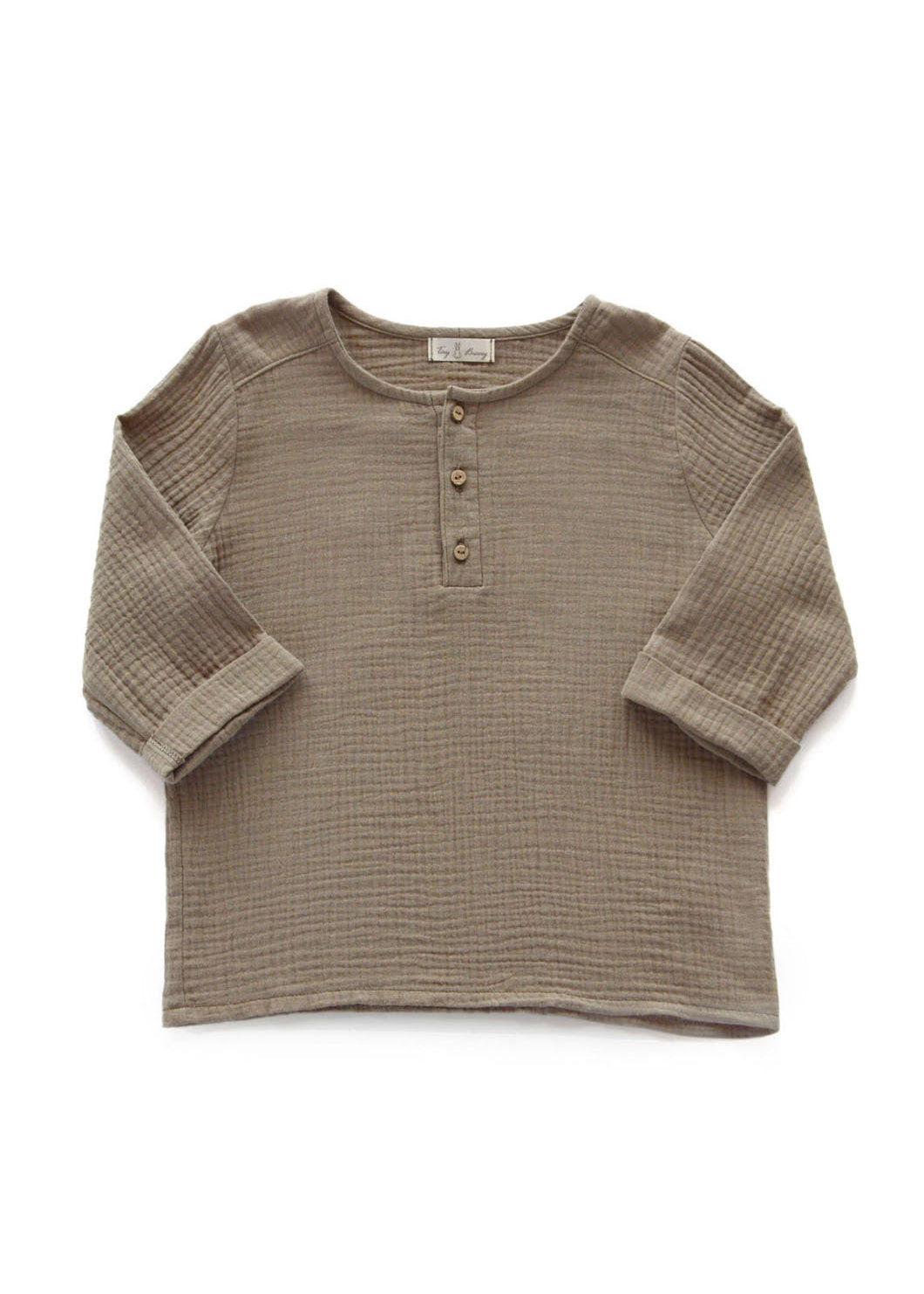 Kids wearing organic cotton muslin shirt in sand - unisex design perfect for summer and hot weather