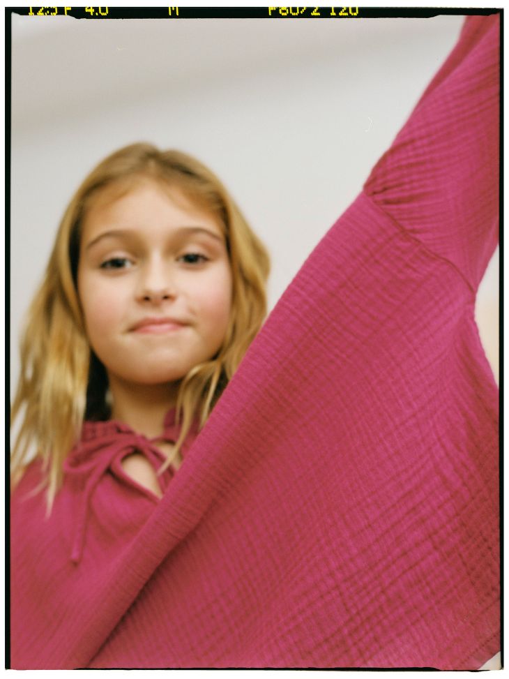Pink sustainable girls blouse is stylish and comfortable. It is made with organic cotton chiffon with a tie-dye print in burgundy colour for trendy girls.