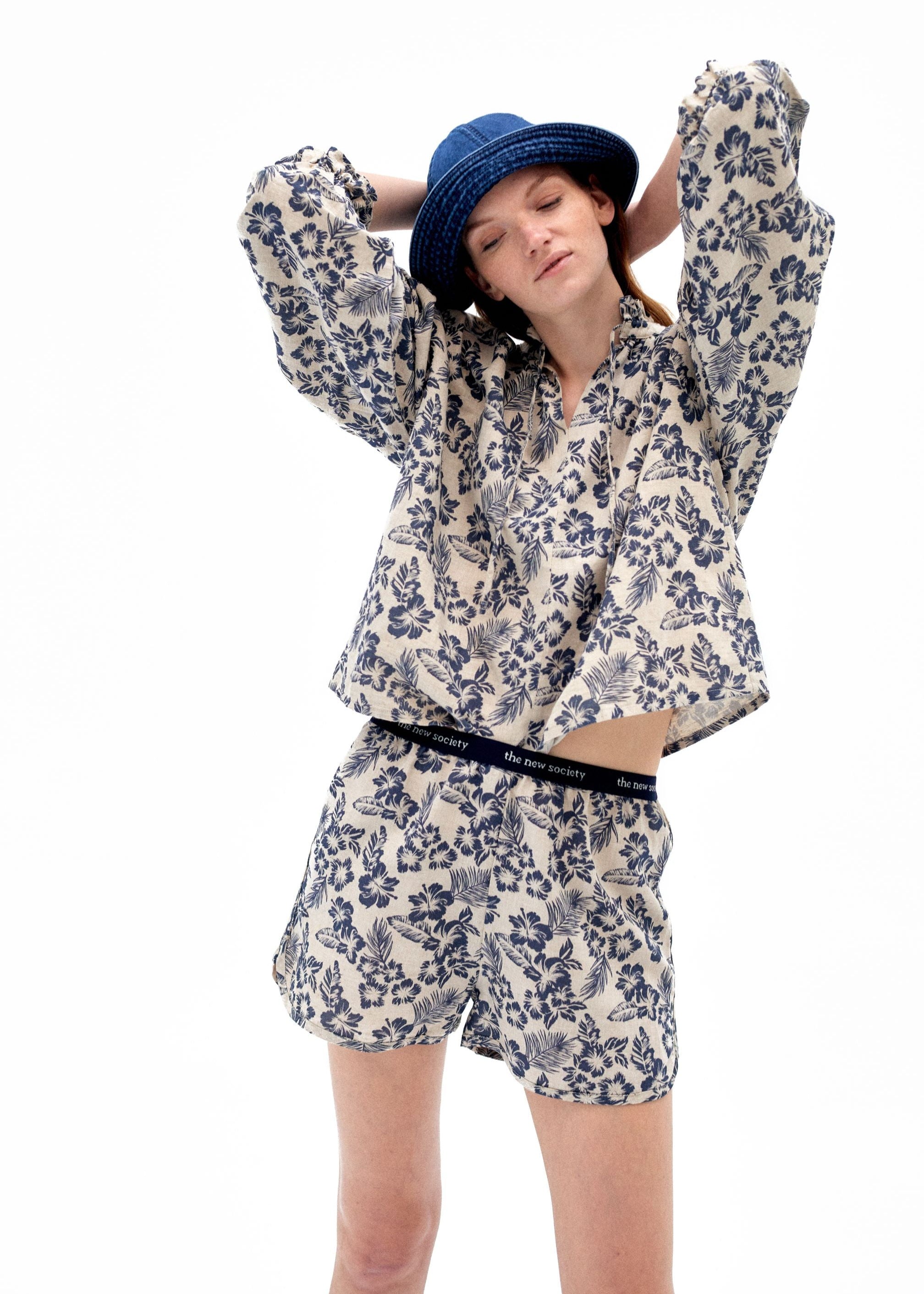 Hibiscus women shorts, side view showing relaxed fit and Portuguese linen quality.