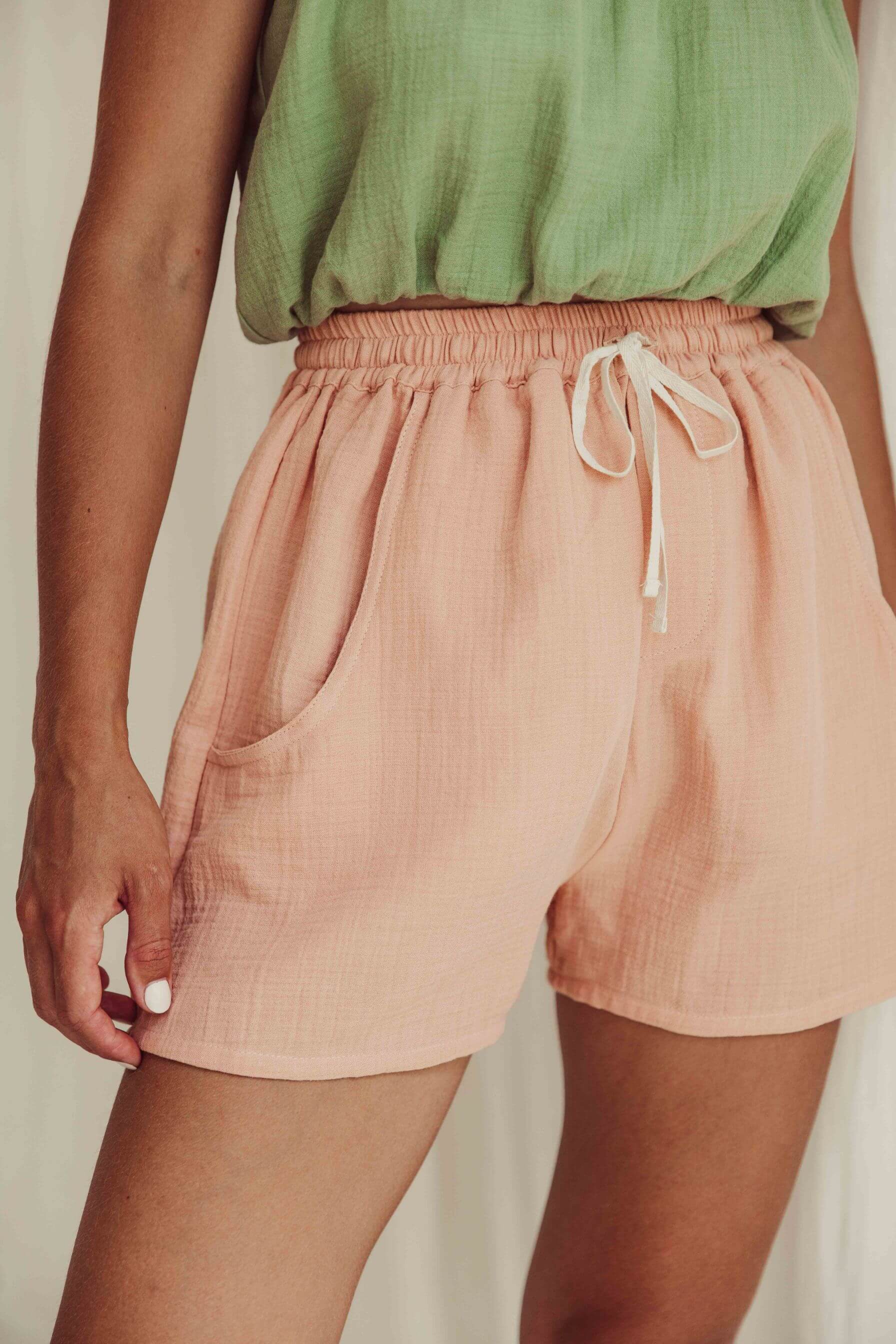 Shop women's summer shorts online in Hong Kong and Singapore. Organic cotton women's shorts in peach colour have 2 pockets and an elastic waist, made by Liilu. MiliMilu offers a wide range of sustainable women's fashion online, women's organic cotton summer clothes and linen dresses with many Mini me styles.