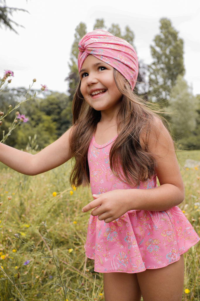The very popular and adorable recycled girl's turban is back in a new print - pink mallow romance. It is made from an SPF 50 protective fabric and designed in a turban-style swim cap. Louise Misha, This versatile kids accessory functions as both a girl's swim hat and a summer hat, providing excellent sun protection.