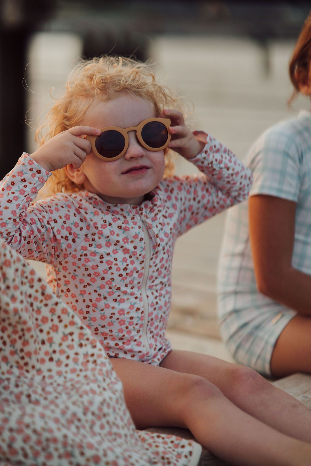 The long sleeve swimsuit in Sunset Meadow, made from recycled fabric and offering UPF 50+ protection, this sustainable girl swimsuit is trendy and practical.