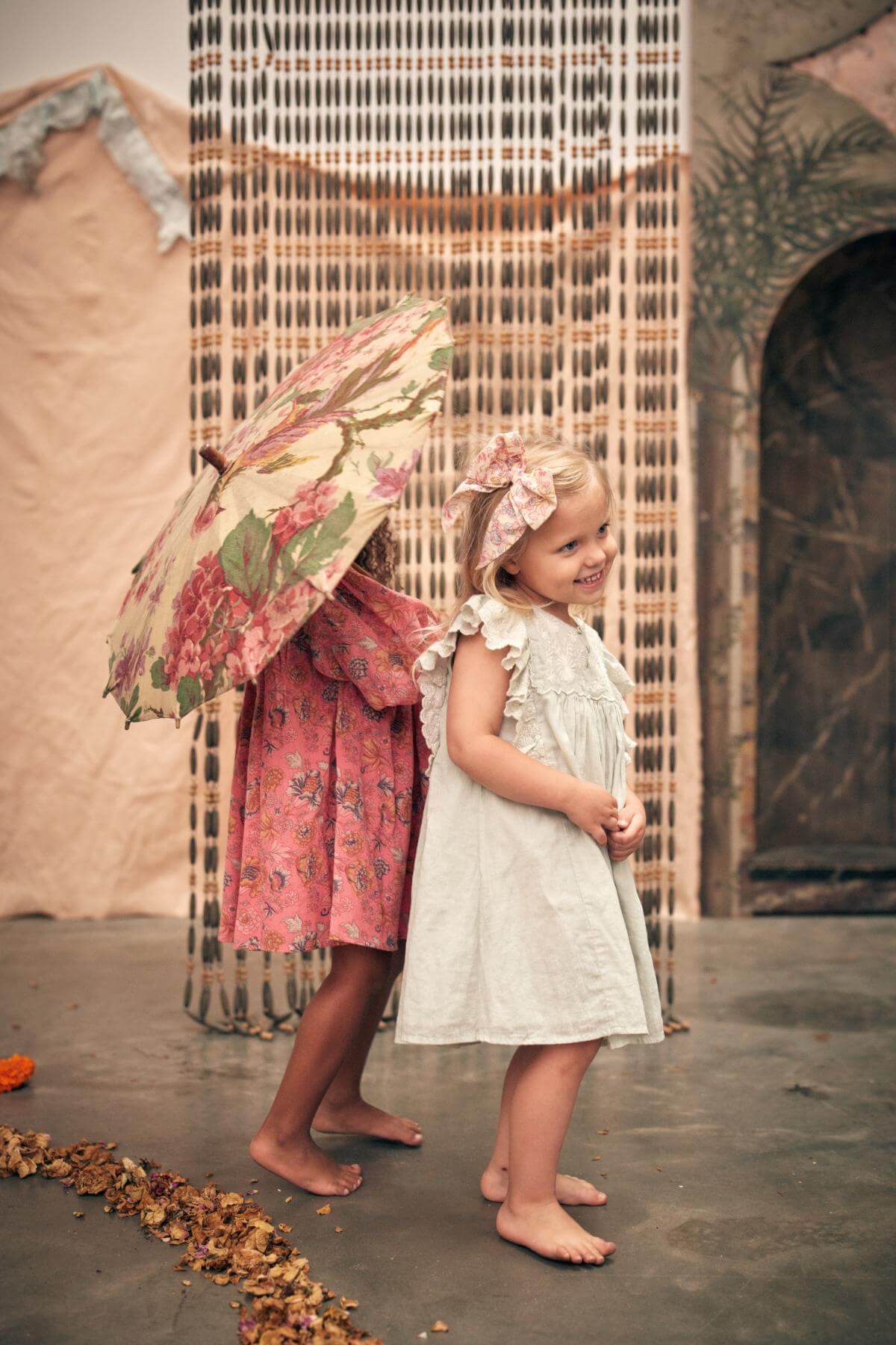 Pink organic cotton girl dress is a perfect summer dress that is flowy, breathable, and lightweight made with organic cotton by Louise Misha. Best girl dress.