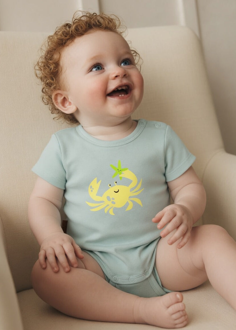 Baby wearing aqua blue crab print bodysuit – organic cotton onesie by Milimilu