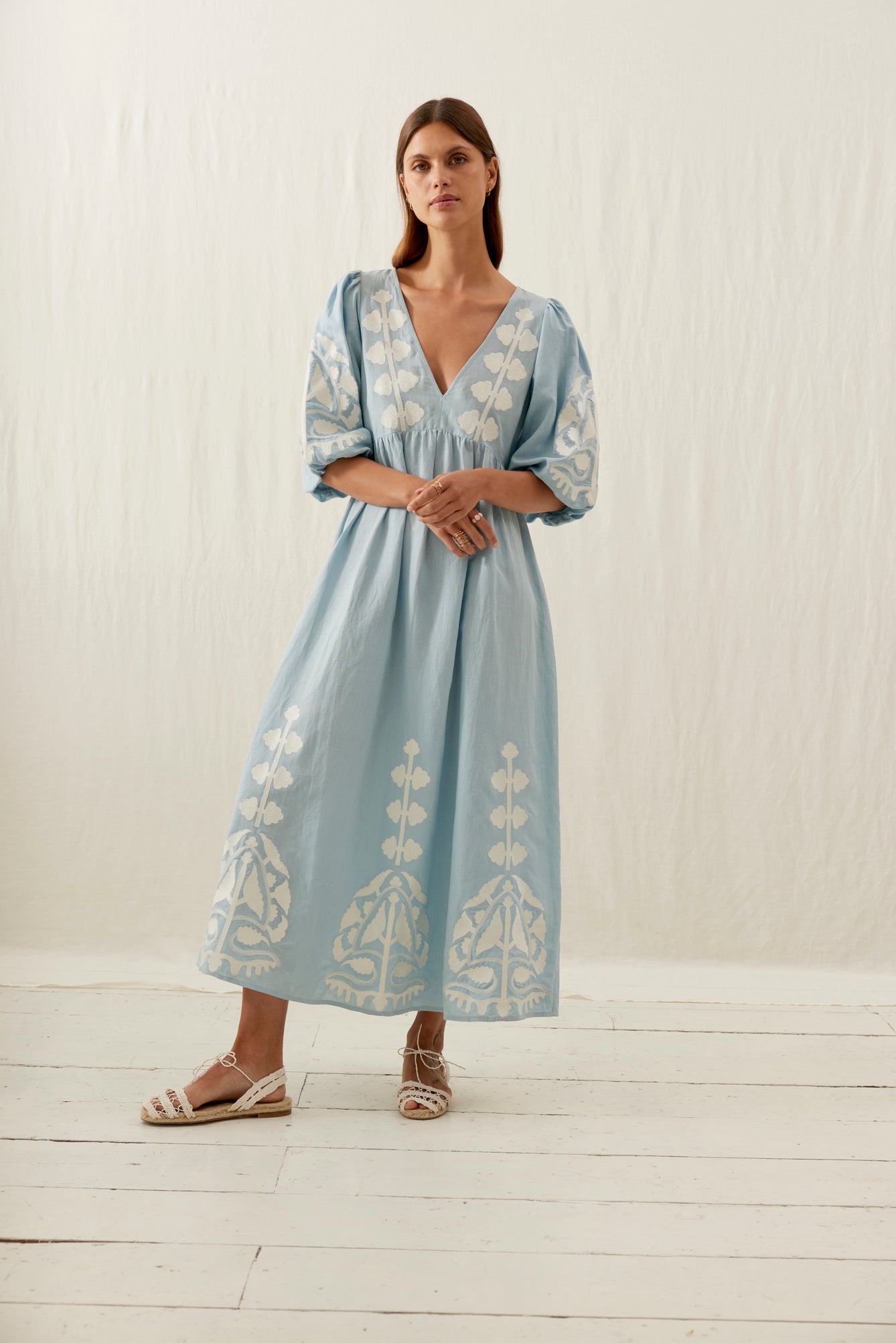 This women maxi dress of cotton in blue summer skies colour is the best summer dress with open back details. The Ilana maxi dress has a deep plunging V-neck and stunning contracted embroideries on the front, bottom sleeves. This women's summer maxi dress, a perfect addition to any capsule wardrobe, shop women fashion.