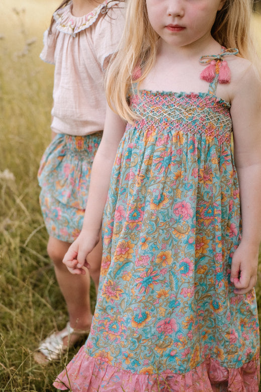 The long girls' summer dress, Marcelina, in water flower print pink, is perfect girl summer dress. The girl long dress have adjustable straps ( to fit you longer) is made with organic cotton by Louise Misha and is part of Mini Me fashion.  Shop girls dresses and kids summer clothing online at MiliMilu.