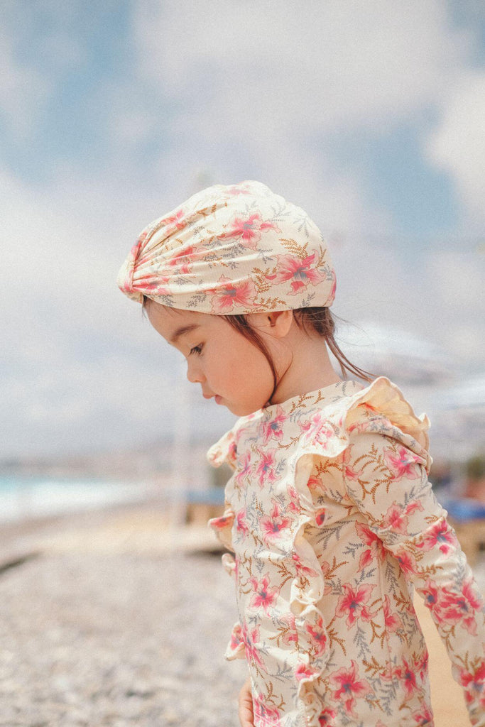 This trendy girl's turban features a raspberry print and is crafted from SPF 50 protective fabric. It has a swim cap-style, which is perfect for the beach and is made from recycled materials by Louise Misha. This is the ultimate summer and swim hat, and is available for purchase online in Hong Kong and Singapore.