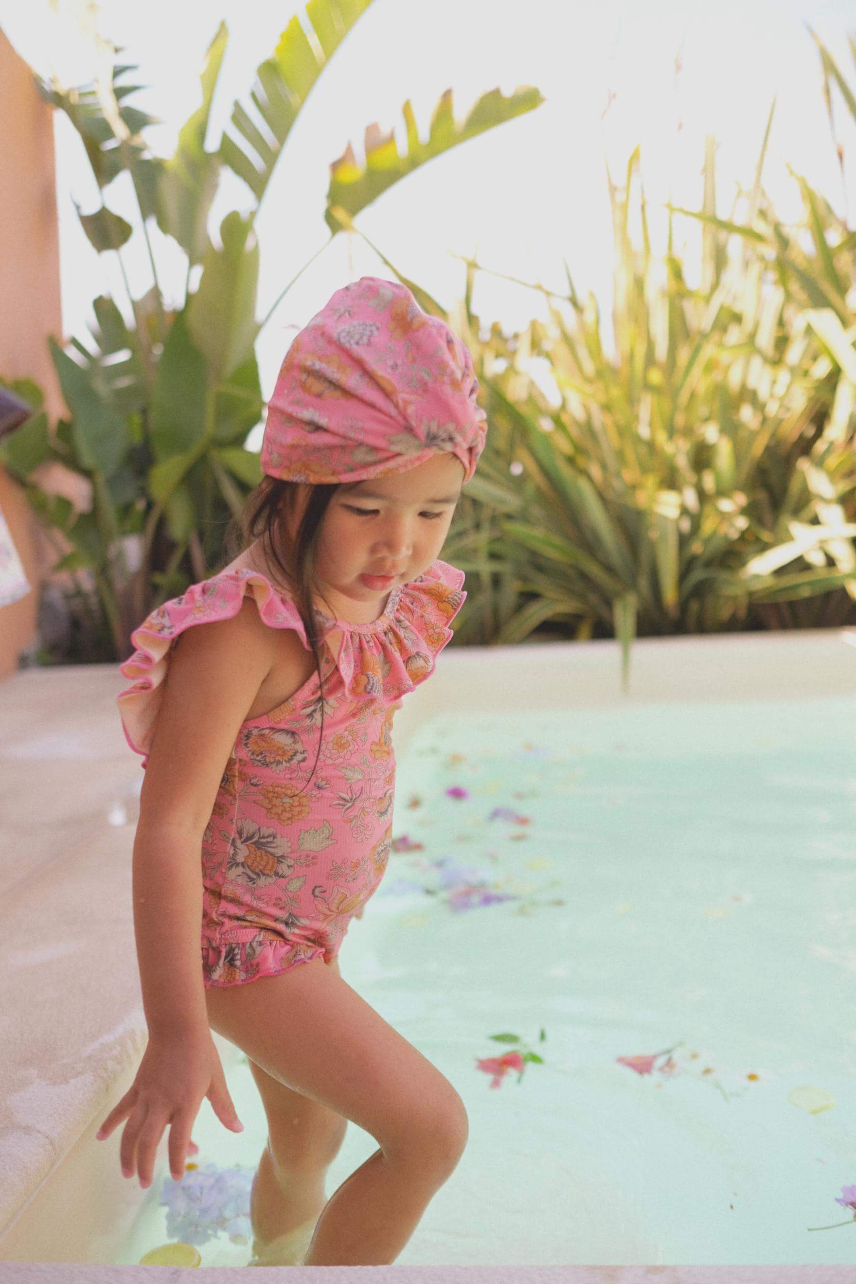 Discover the new strawberry turban for girls - now with SPF 50 protection. Perfect for the beach or swimming. Check out the lightweight pink beach hat and girls swim hat from Louise Misha for a must-have summer accessory. Shop online for high-quality girls' clothing and girl's accessories in Hong Kong and Singapore.