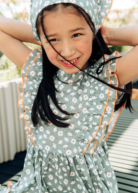 Girls' green flower print dress with orange frills by Hebe — breathable cotton, ethically made in Latvia | MiliMilu