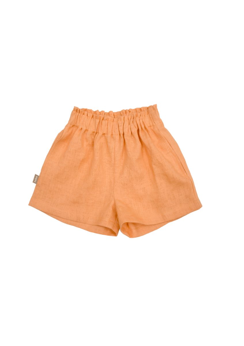 The sustainable and breathable girl's Breathable and stylish girl linen shorts  in orange colour with pockets. Made with high-quality European linen. MiliMilu offers sustainable fashion for kids.