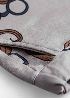Boy wearing organic cotton joggers with moustache print, comfortable fit for active kids.