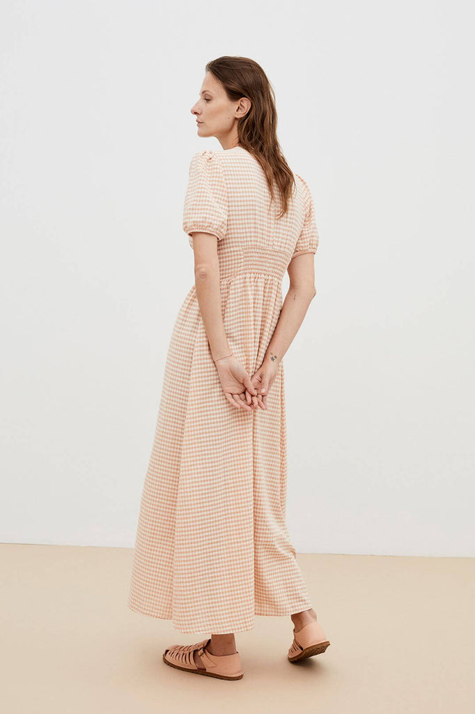 Check out our Petra women's summer dress - made from organic cotton, it's perfect for hot weather. Shop our sustainable fashion dresses online in Hong Kong and Singapore with MiliMilu. Organic cotton women's midi dress is the perfect summer dress with light checked and volume sleeves and V neck and volume sleeves.