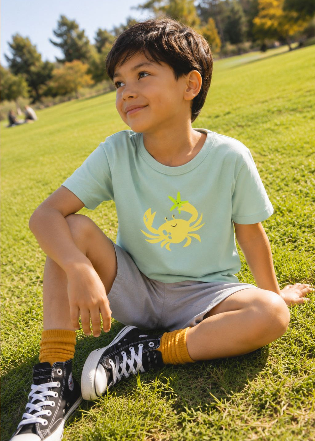Child wearing aqua blue crab print T-shirt – organic cotton kids top by Milimilu