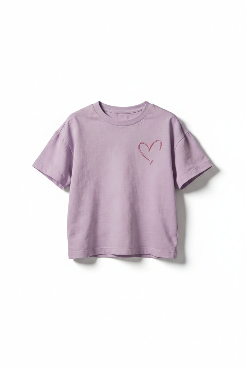 Purple t-shirt with a red heart design on a beige background