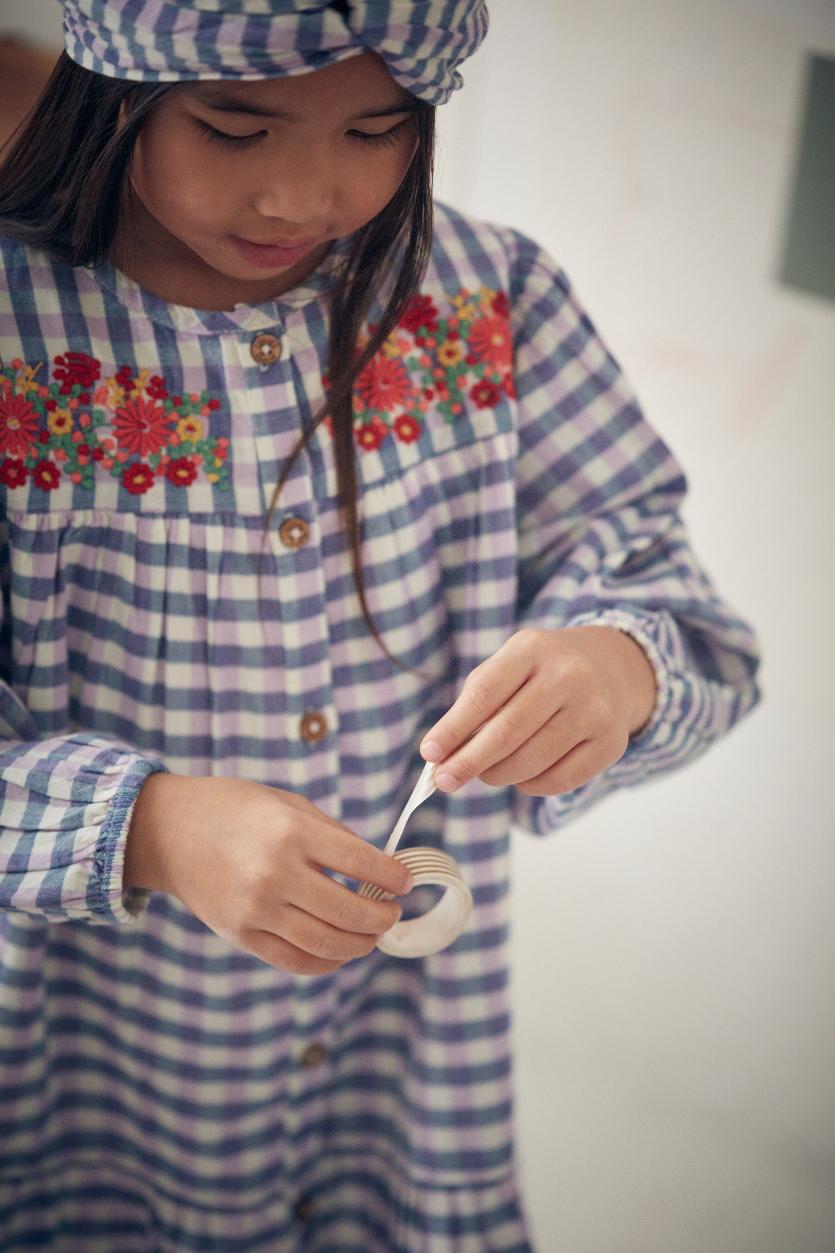 Shop organic cotton checker dress with embroidery in blue and purple colours by Louise Misha. Shop sustainable kids fashion and organic cotton kids clothing made for trendy kids for practical parents.