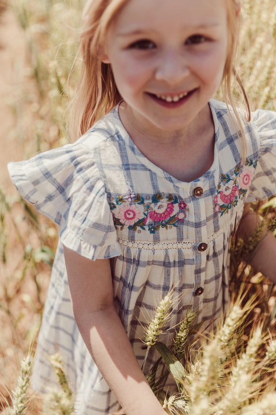 Girl summer dress - Caroline in blue river checkered pattern made from high-quality lightweight organic cotton by Louise Misha. Shop girls summer clothing.