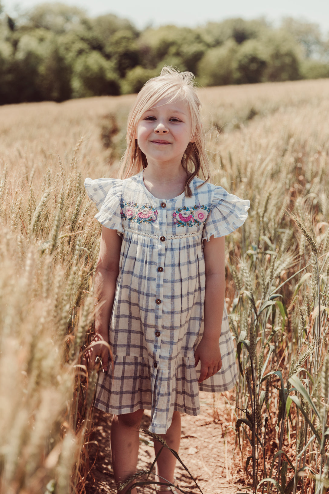 Girl summer dress - Caroline in blue river checkered pattern made from high-quality lightweight organic cotton by Louise Misha. Shop girls summer clothing.