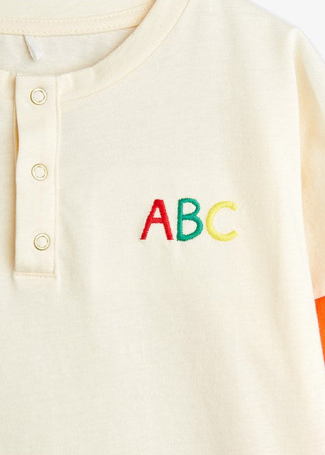 Close-up of ABC embroidery detail on GOTS-certified organic cotton kids shirt - Mini Rodini