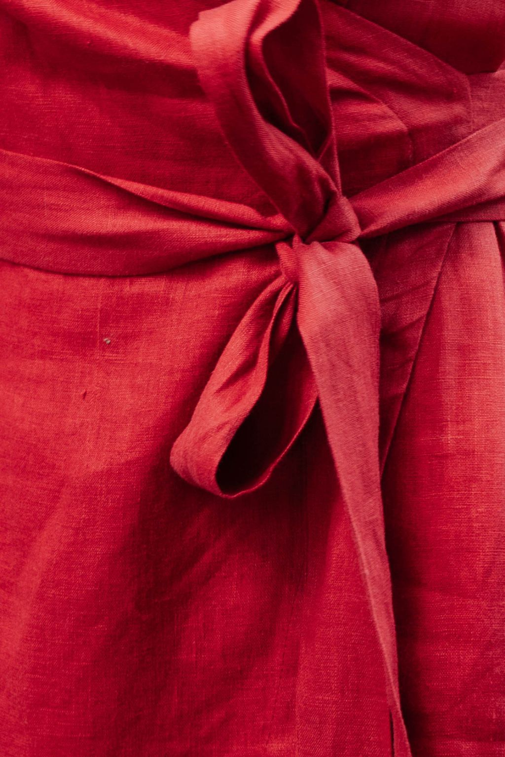 Red linen wrap dress showing elegant drape and fit.