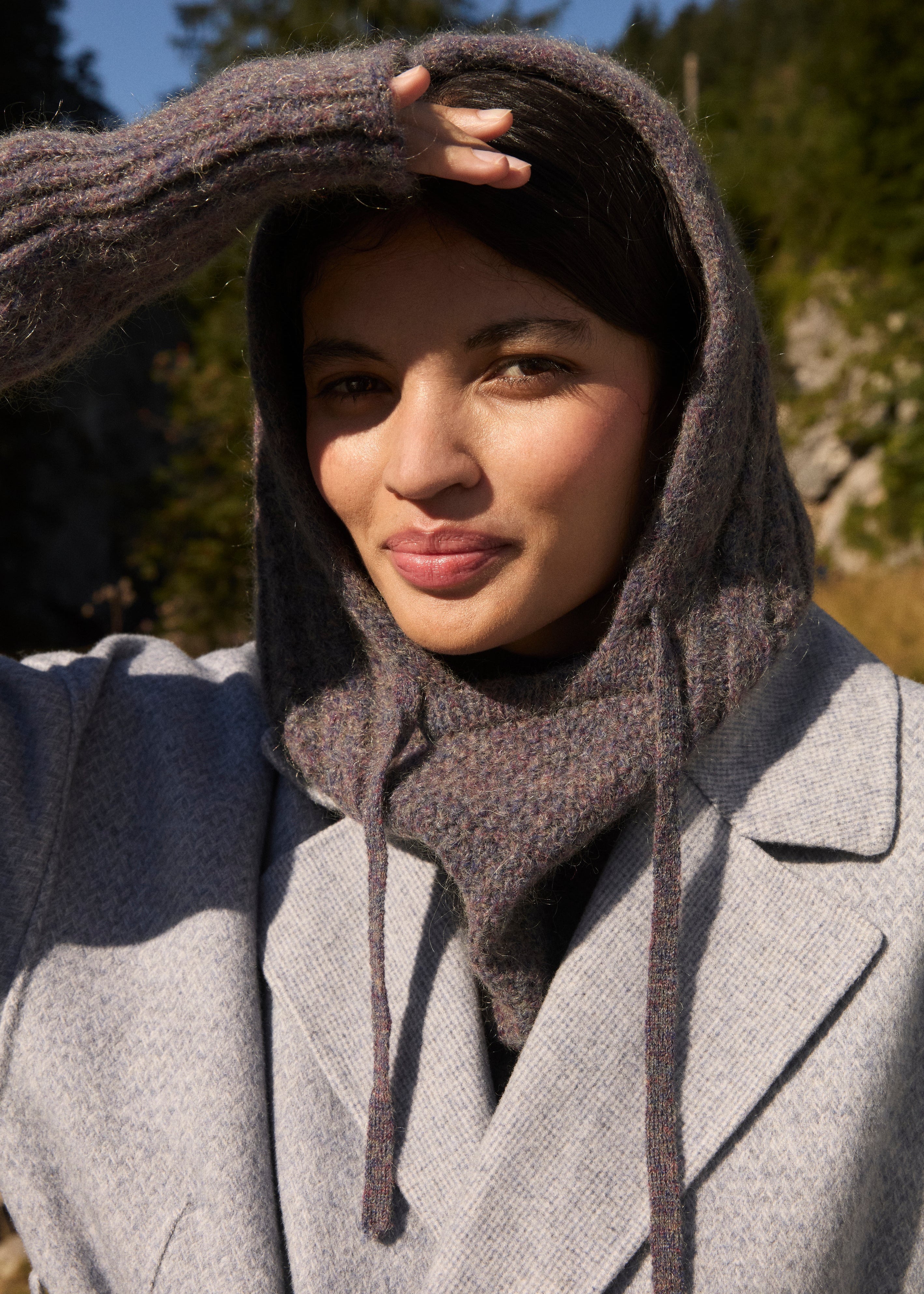 Woman wearing storm grey merino wool hood by Louise Misha - sustainable winter accessory