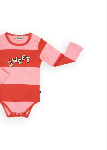 Organic cotton baby clothing featuring adorable pink baby girl bodysuit. Made with stretchy GOTS-certified cotton for sensitive and eczema prone skin.