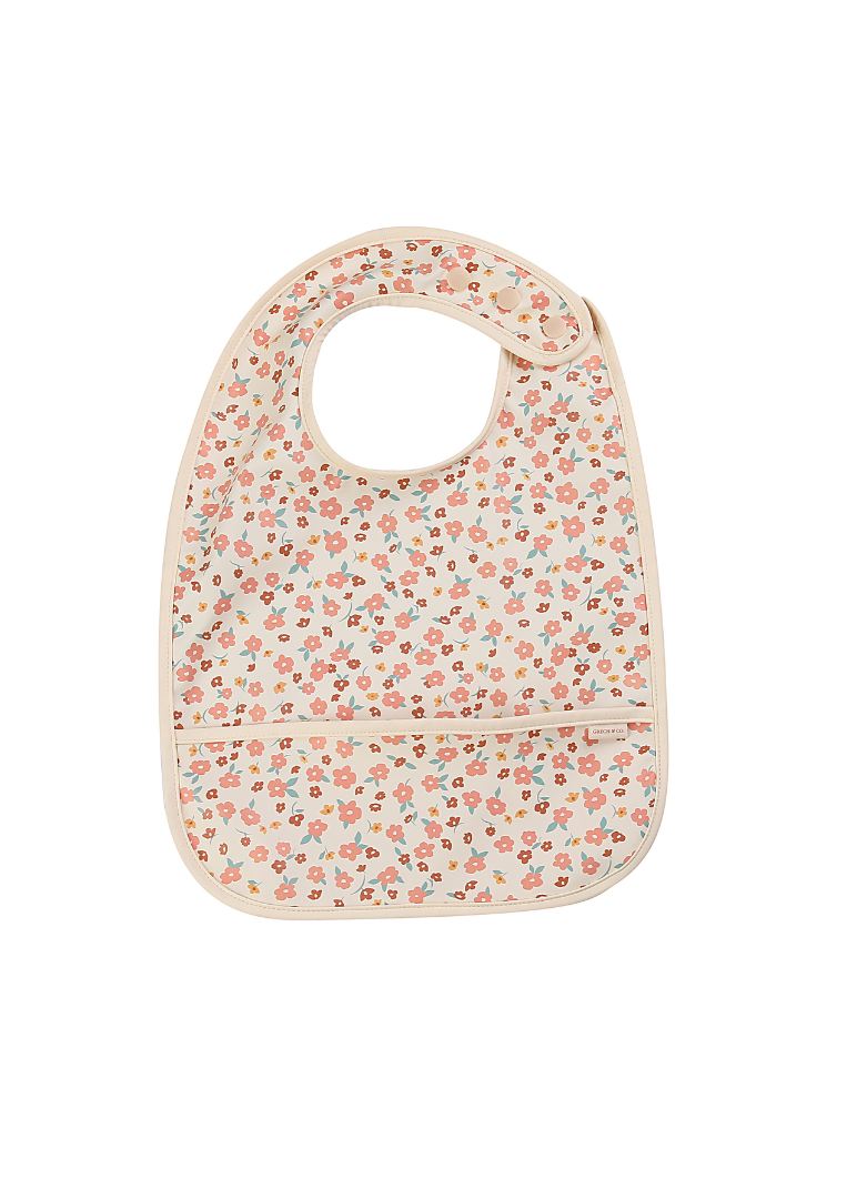 Grech & Co. sustainable baby bib in Sunset Meadow floral print – OEKO-TEX certified PU with adjustable button closure