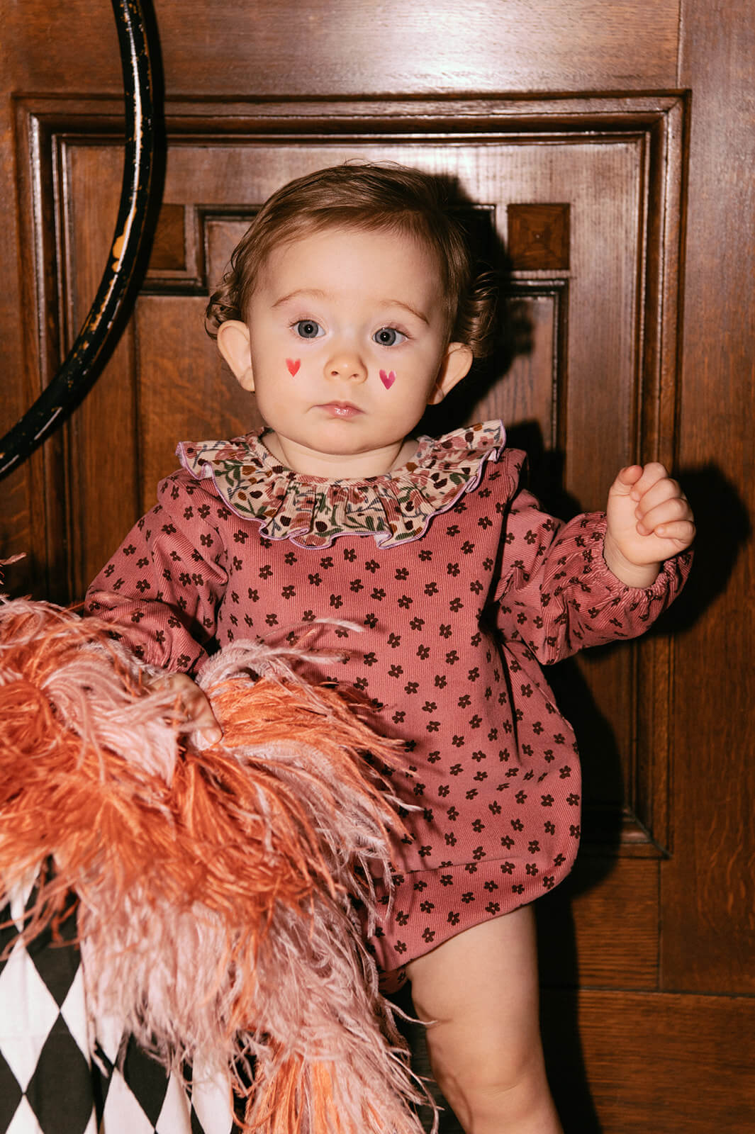 Pink velvet baby romper with a beautiful flower print - the best sustainable baby clothing. The baby girl romper with flowers is made of lightweight velvet.