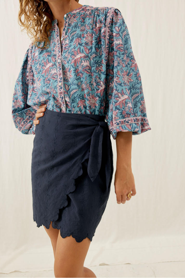 Shop the little black mini skirt Charlie with embroidery fabric and scalloped edges. The black mini skirt are made with breathable cotton by Louise Misha.