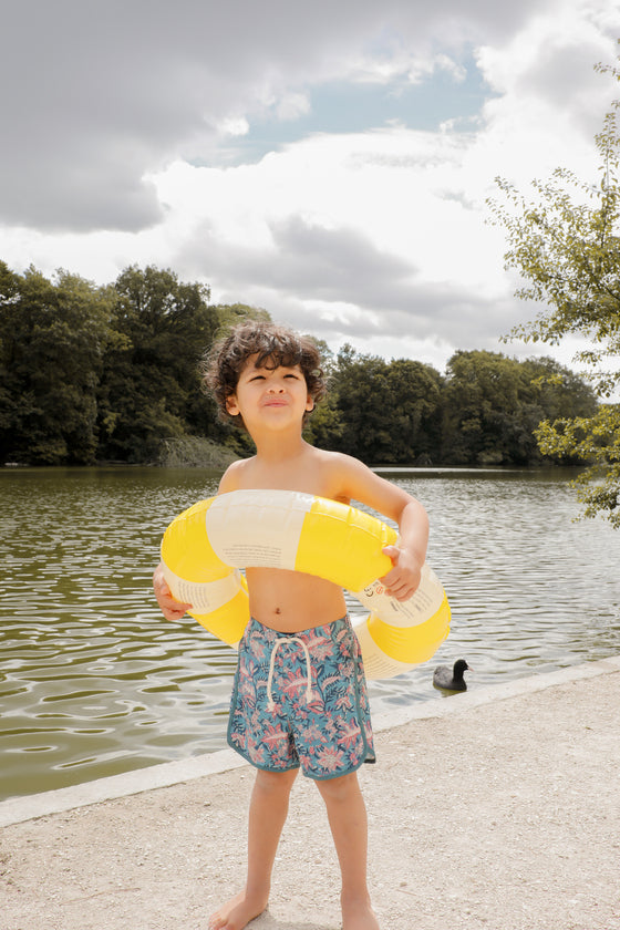 Boy swim trunks in blue, these swim shorts provide SPF 50 sun protection by Louise Misha. Shop best kids sustainable swimwear online and gifts online.