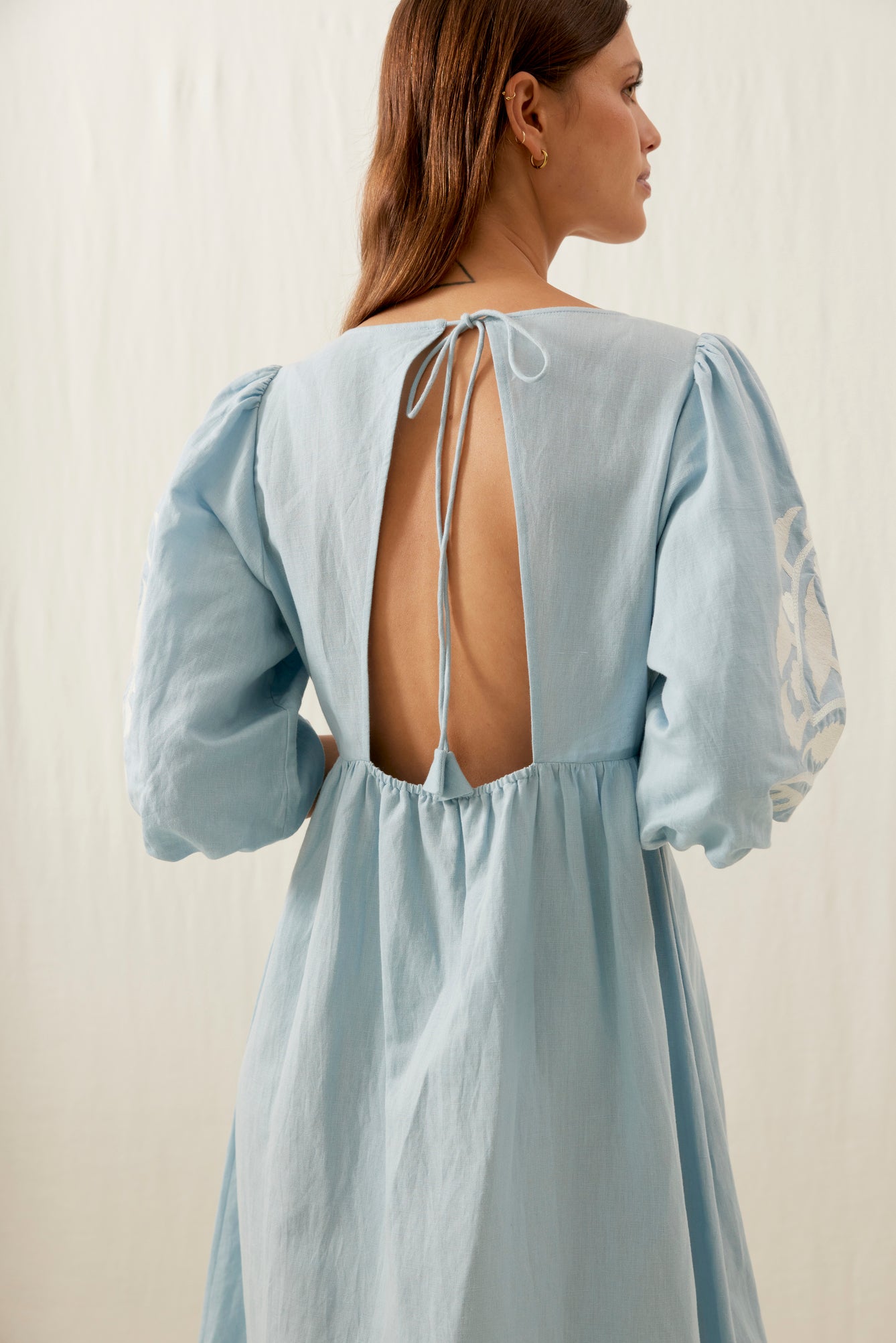 Women maxi dress in blue is the best summer dress with open back. The Ilana maxi dress has a deep V-neck & contracted embroideries on the front by Louise Misha.