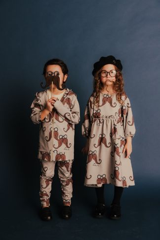 Boy wearing organic cotton joggers with moustache print, comfortable fit for active kids.