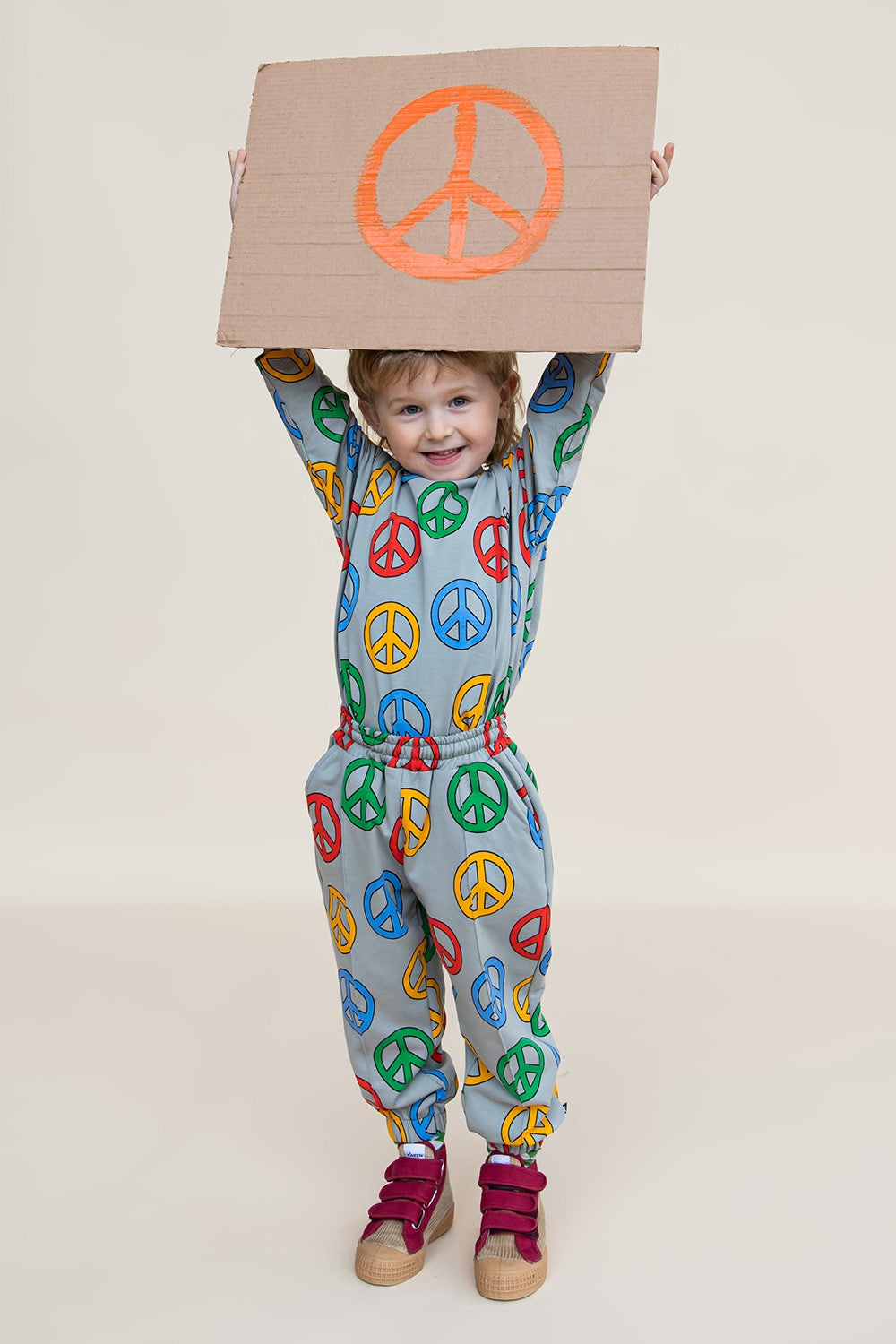 SChild wearing CarlijnQ organic cotton Peace joggers - full body view