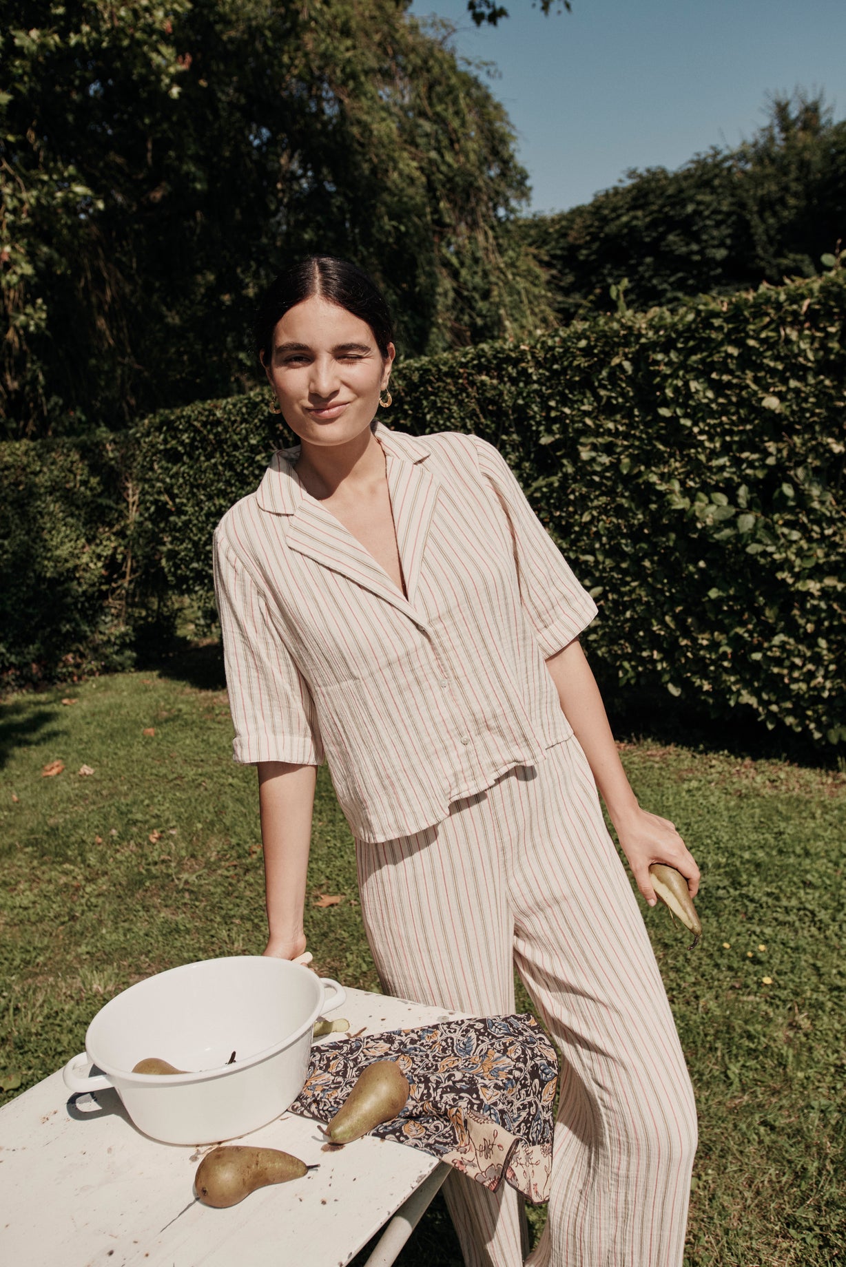 Breathable organic cotton pyjama set features a loose fit, a slightly cropped top with a neck collar, shirt sleeves and an elastic waistband, by Louise Misha.