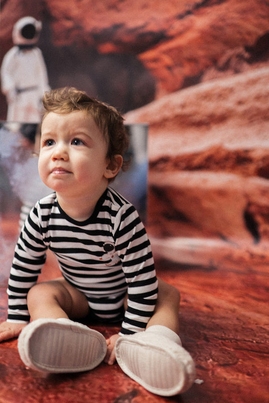 This adorable onesie features black and white stripes with an astronaut print, combining fashion and comfort. Crafted with the most sensitive and eczema-prone skin in mind, this bodysuit is incredibly soft and gentle. Also, the best baby gift.