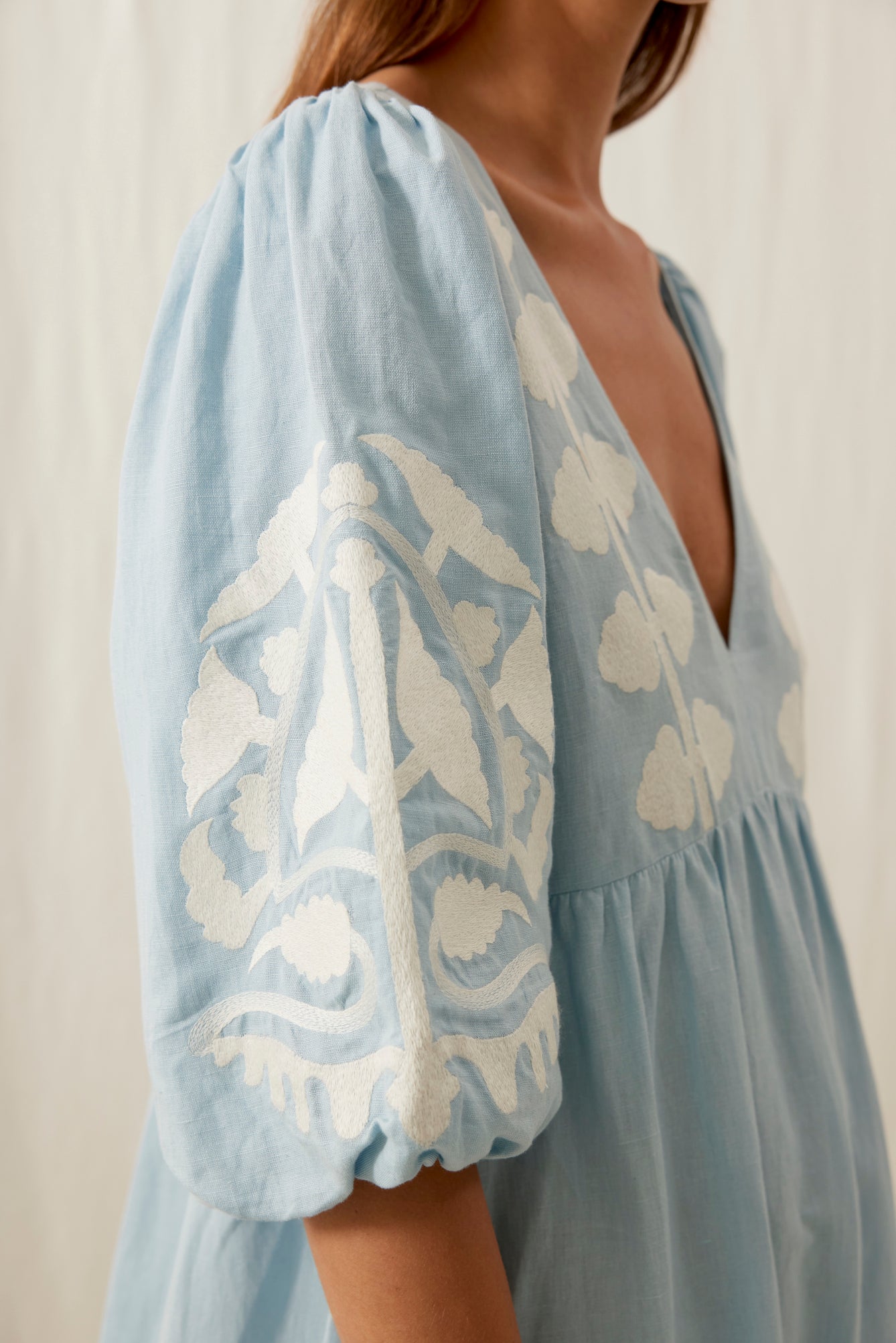 Women maxi dress in blue is the best summer dress with open back. The Ilana maxi dress has a deep V-neck & contracted embroideries on the front by Louise Misha.
