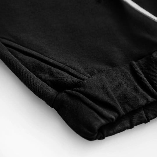 The organic cotton kid's black pants are comfortable, breathable and soft for everyday wear. They are made with organic cotton by Dear Sophie in black colour. Organic pants for girls and boys are stylish, comfortable and long-lasting. Sustainable kids clothing from MiliMilu offer practical kids pants/joggers.