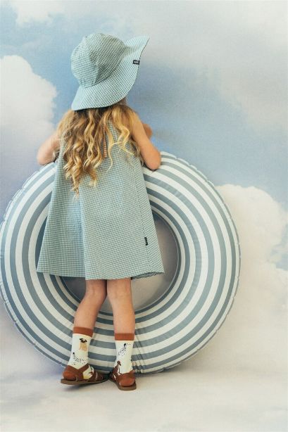 The light Mint Checkered summer hat for kids with straps. Mint kid's hat is made with lightweight and breathable organic cotton (GOTS) in green-blue checkered.