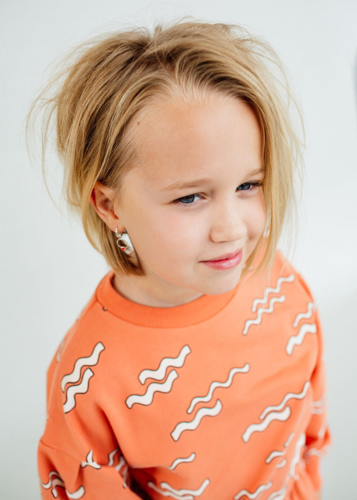 Girl wearing Wave organic cotton jumper with puff sleeves, GOTS certified cotton kids clothing.