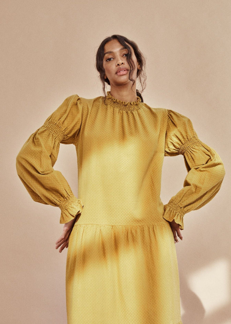 Brigette organic cotton smock dress in mustard by The New Society — high neck, dobby texture, made in Portugal