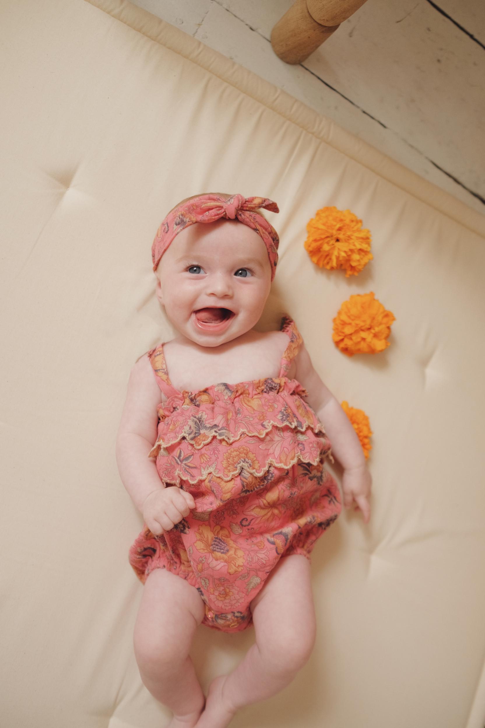 Pink baby girl summer romper is made with lightweight and breathable organic cotton by Louise Misha. Shop the best organic cototn baby clothing and baby gifts.