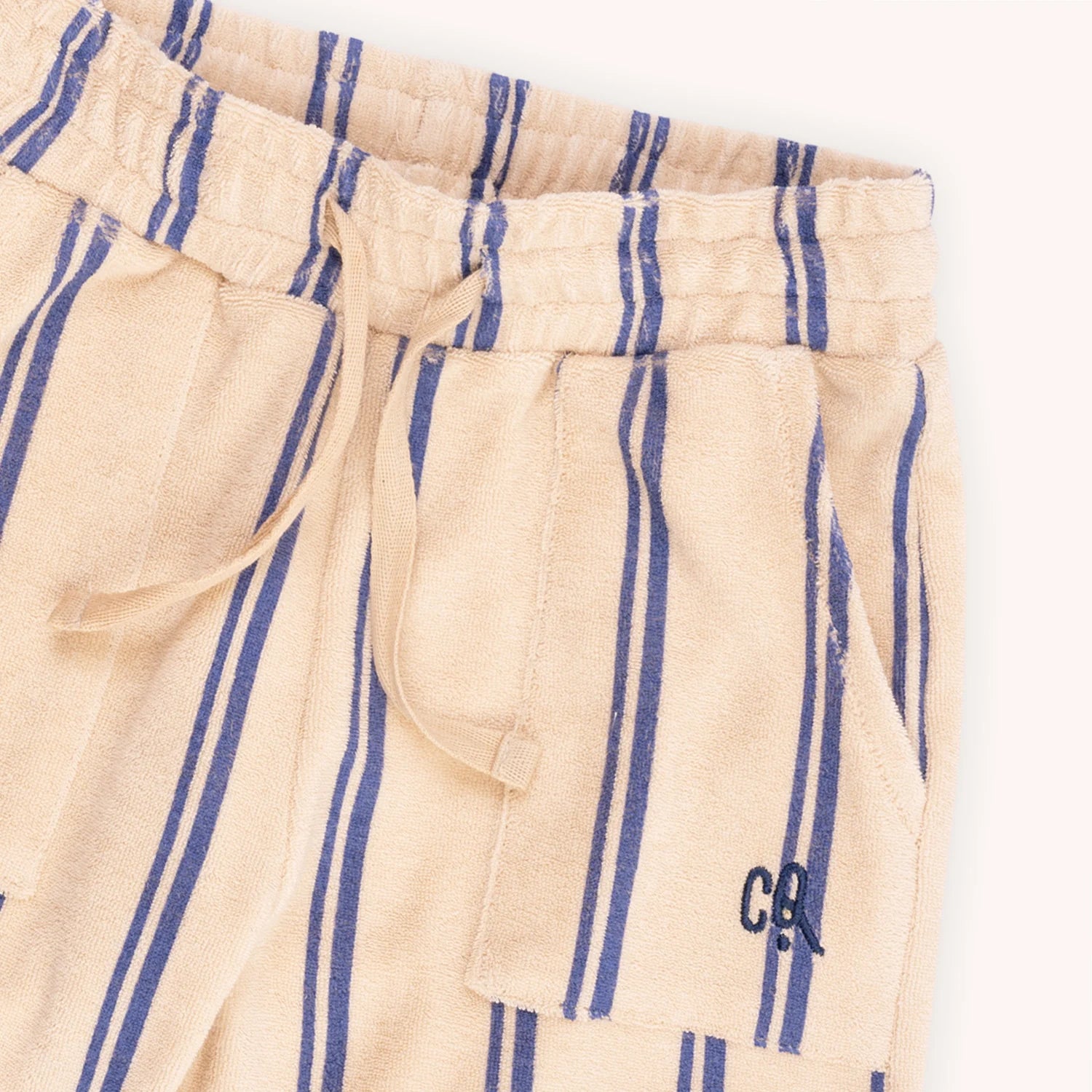 Kids' shorts from organic terry towel light fabric from CarlijnQ are designed in a loose fit with two pockets and a drawstring. The best kids' shorts for comfort and style. The breathable and stylish organic cotton terry shorts are with blue stripes. MiliMilu offers sustainable kids and teen clothing in Hong Kong.