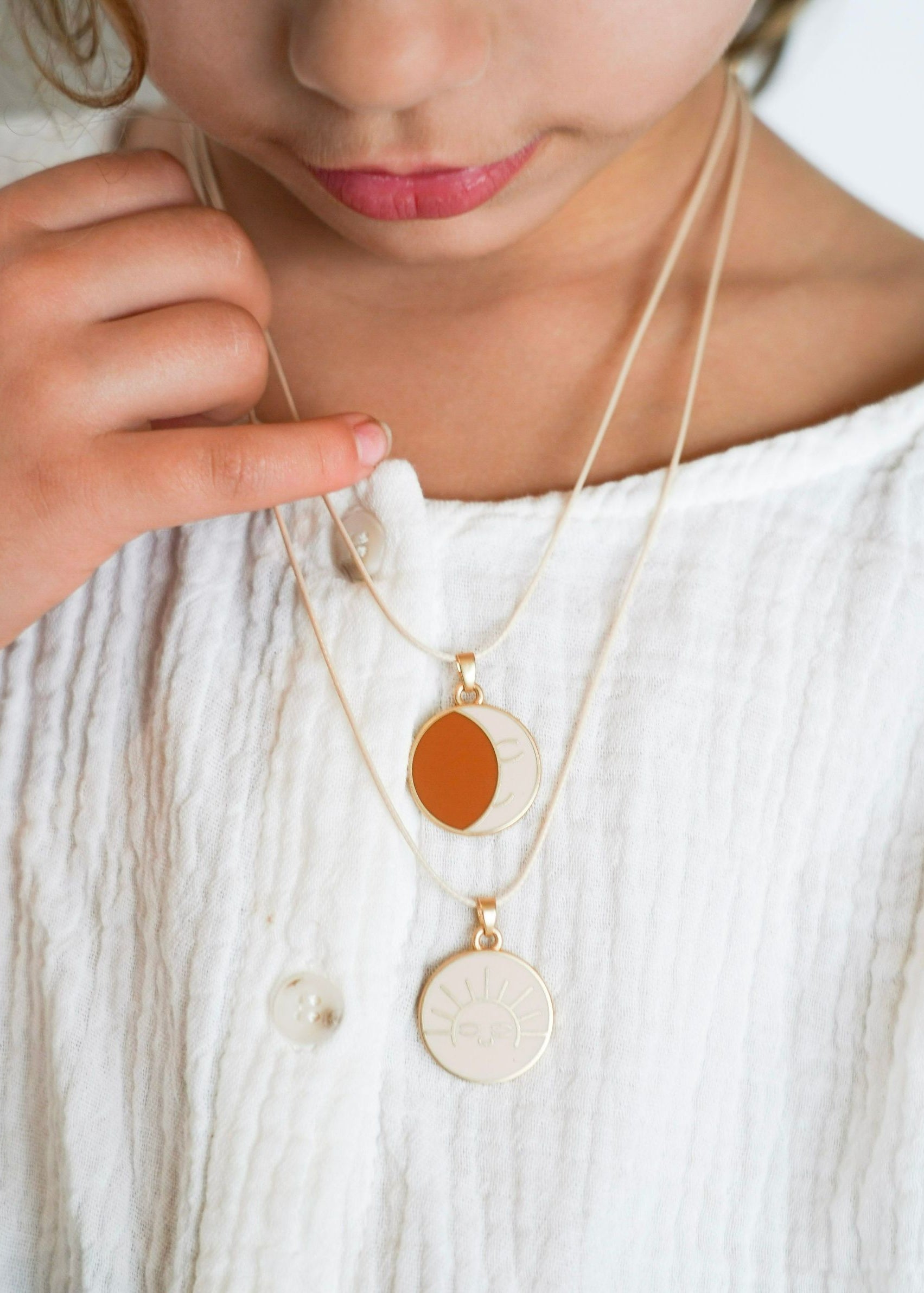 Girl wearing Grech & Co sun and moon friendship necklace eco-friendly kids jewellery HK SG UK